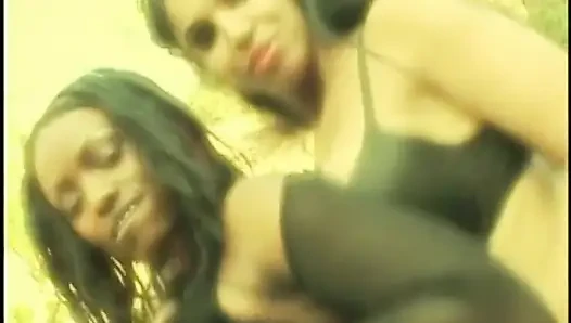 Two ebony honeys share one hard cock in front of the fireplace