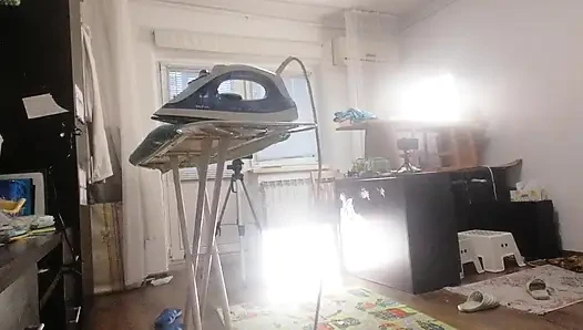 Sexy brunette doing naked chores around the house.