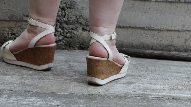 Chubby legs in high platform sandals.