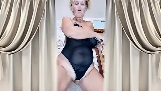 Cheerful housewife Lukerya in the kitchen in transparent lingerie