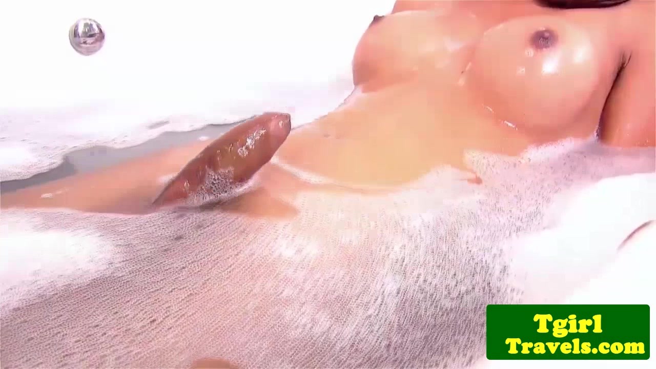 Bathing ts Bell puts a huge dildo in ass