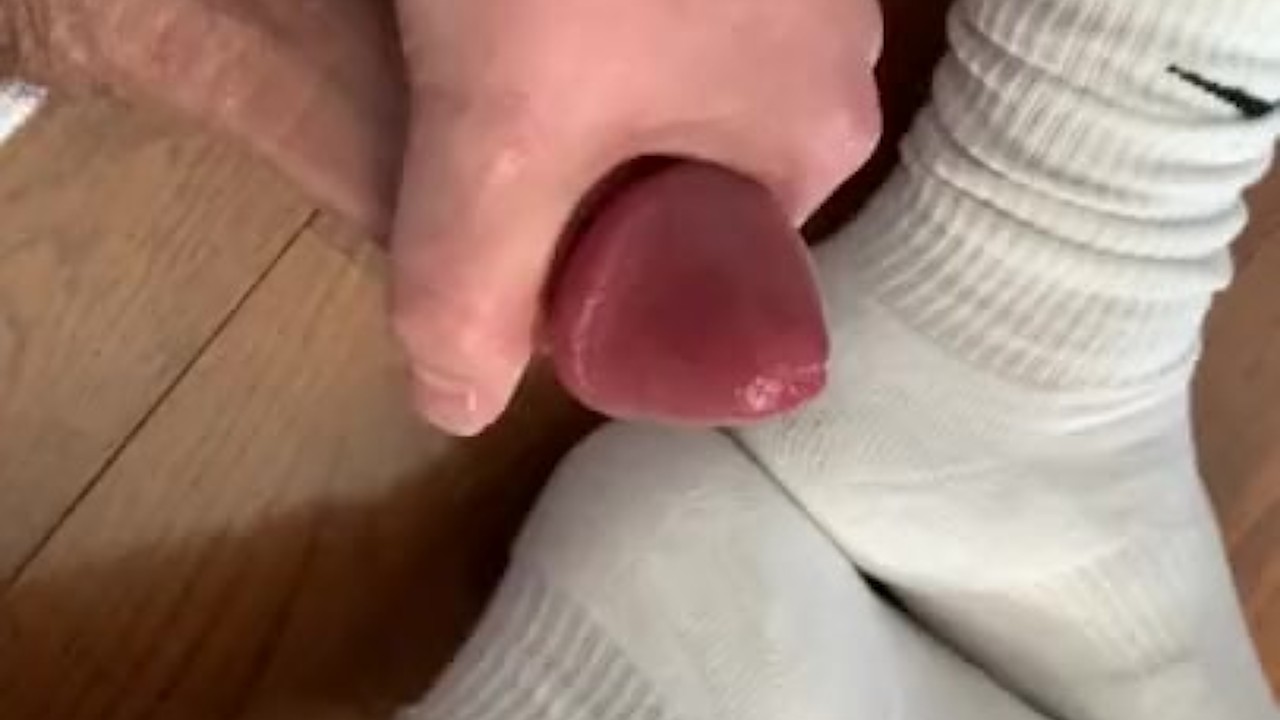 Football player jerks lubed up cock over clinched feet *FOOT FETISH