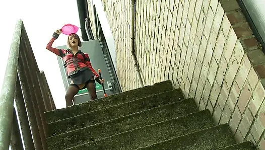 Kinky slut in latex and stockings masturbates outdoors with a toy