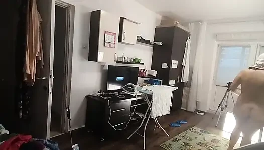 Sexy brunette doing naked chores around the house.