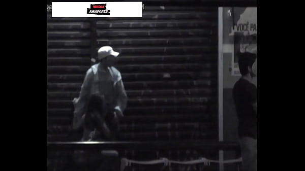 Woman performs oral sex on her partner at a bus stop on the street