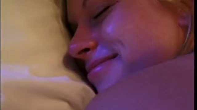 Young blonde smiles as she gets nailed doggy style in bed