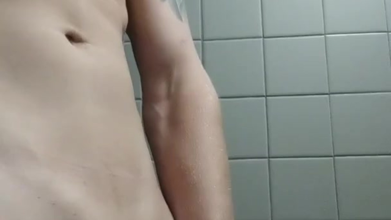 Guy strokes big cock in bathroom
