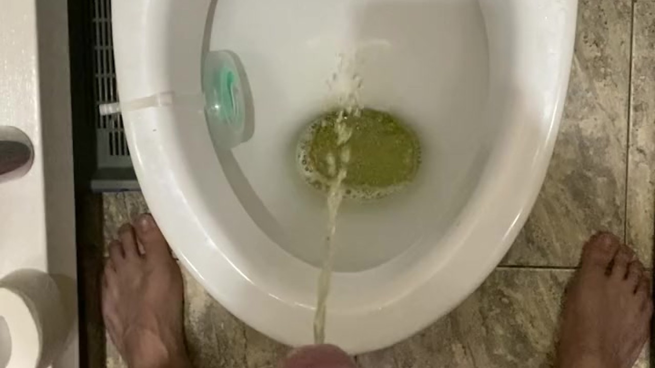 Morning pissing in the toilet with an uncircumcised penis, view from the eyes