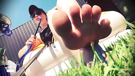 Little weak man destroyed by giantess feet outdoors