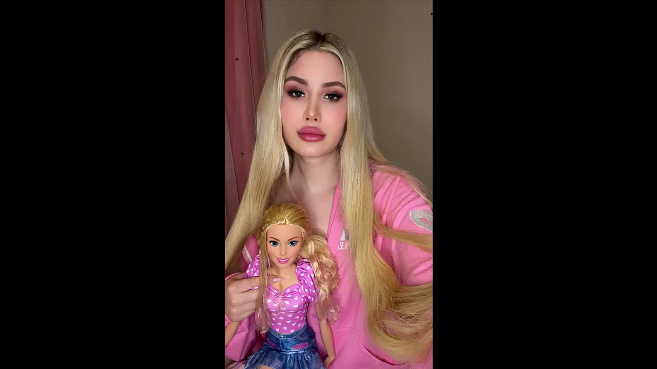 Sweet blonde beauty in pink teasing with her doll