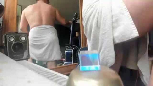 nude male on webcam with a towel