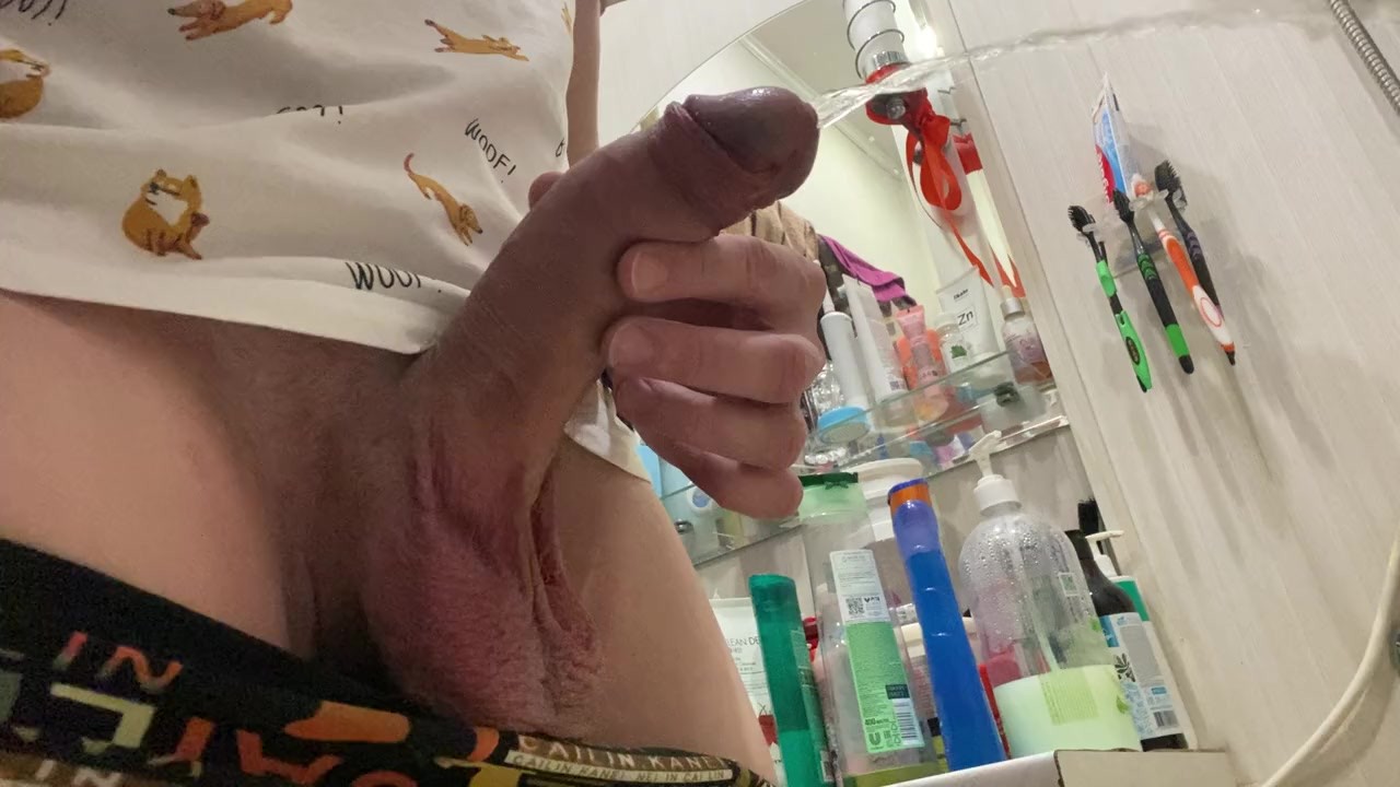 Morning pissing of uncircumcised penis in the bathroom